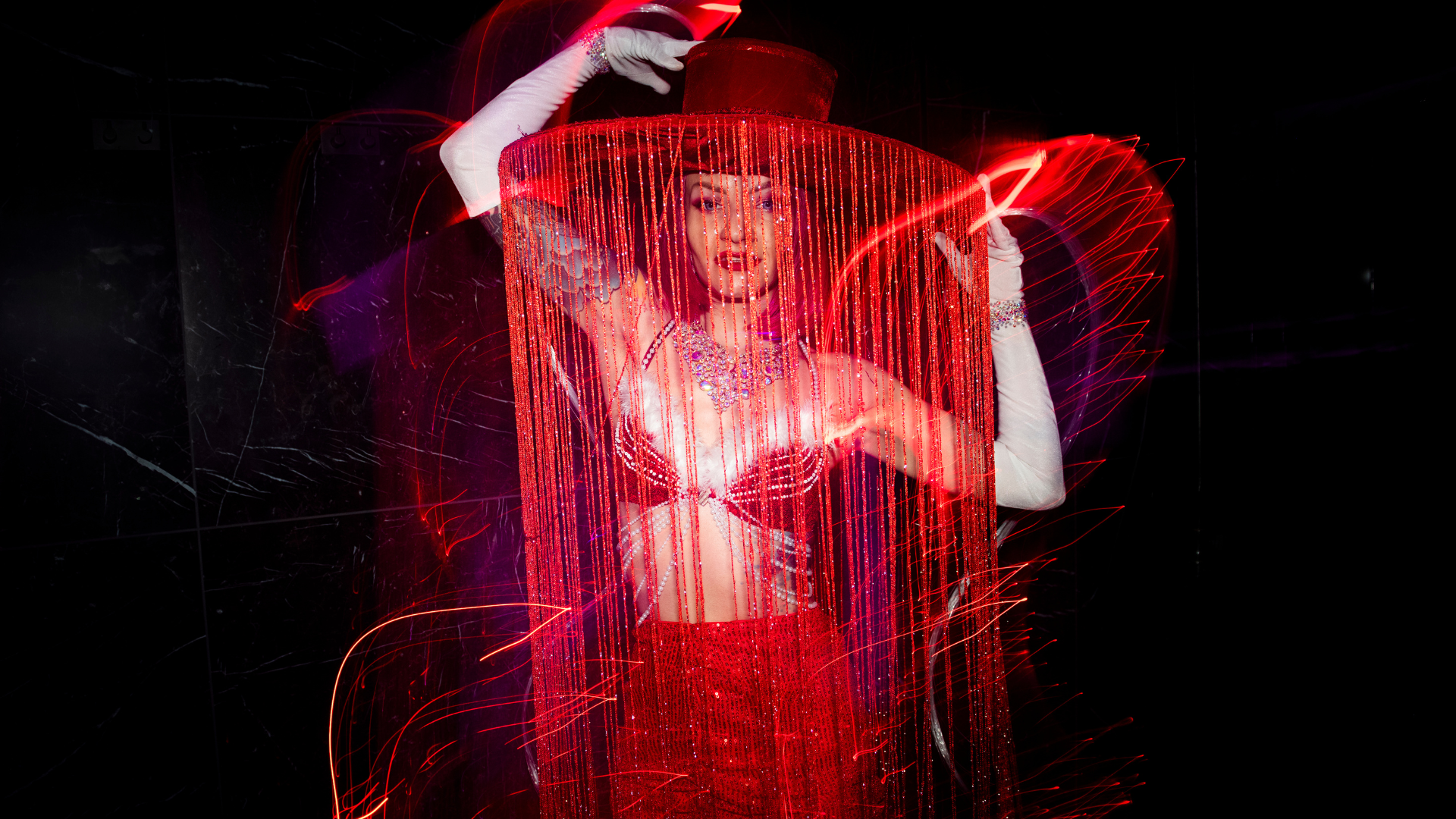 A performer in a glamorous show outfit at Velvet Room, exuding elegance and sensuality in a luxurious Stockholm setting.